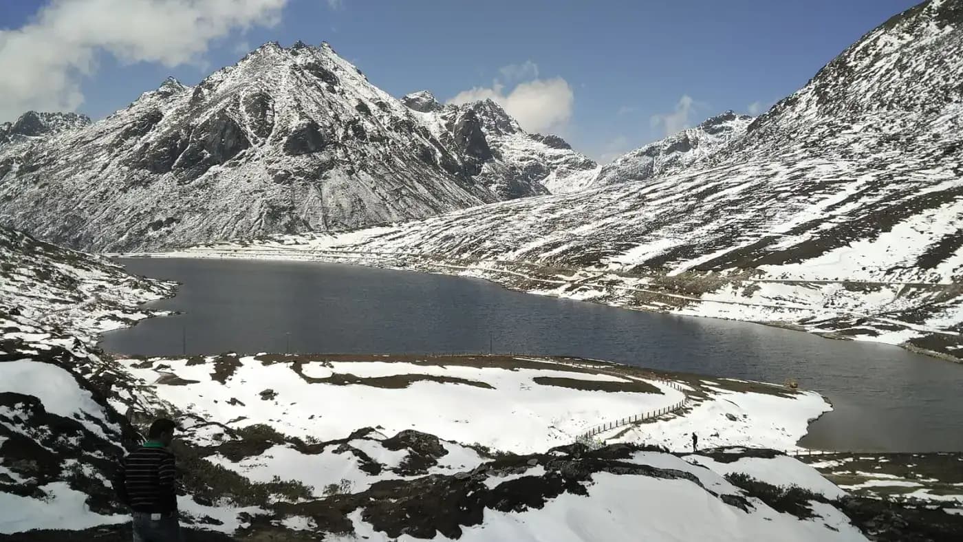 Frozen high-altitude lake surrounded by snow in Tawang district