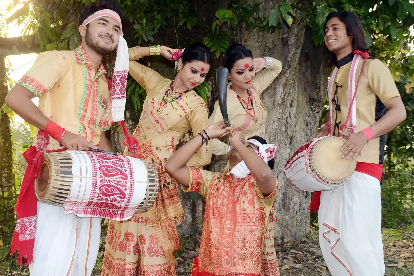 Bihu dancers with dhol drums in traditional Assamese attire