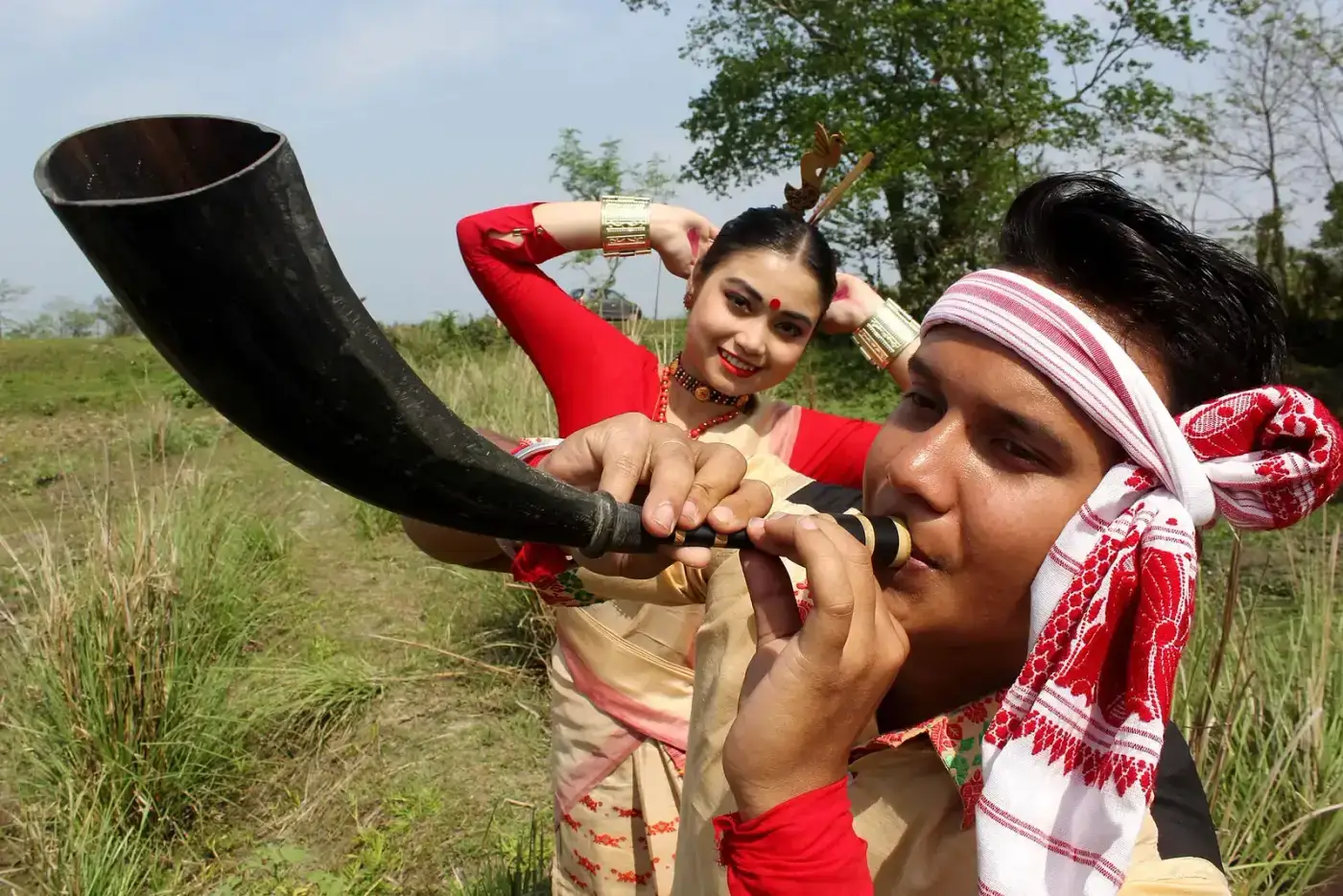 Bihu performer playing the pepa buffalo-horn pipe