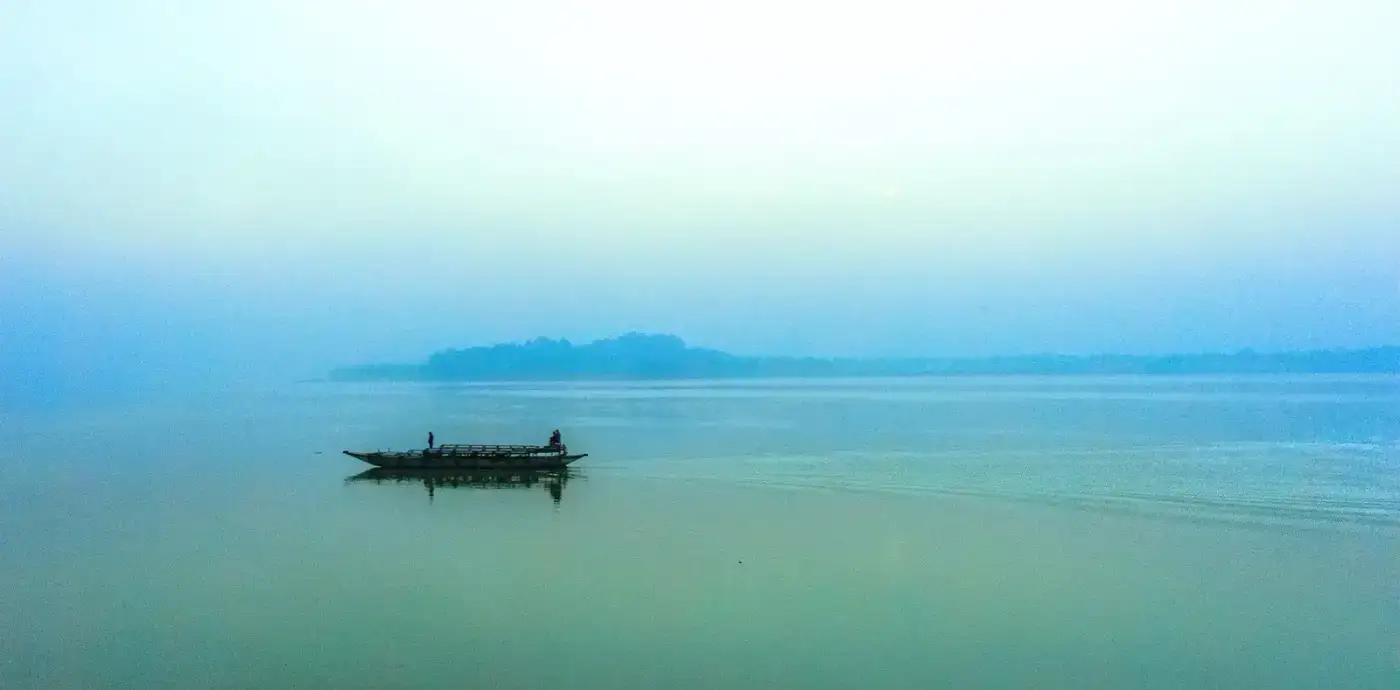 Boat on the misty Brahmaputra river, Assam