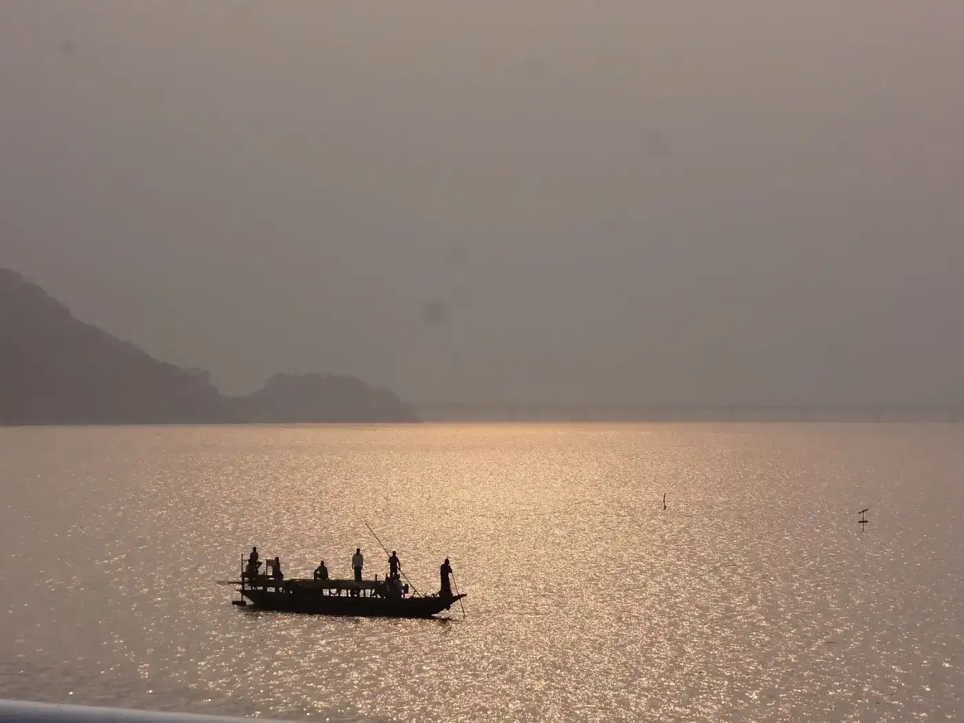 Country boat silhouetted on the Brahmaputra at sunset