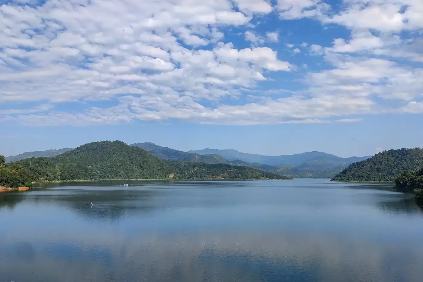 Blue waters of the Doyang reservoir among hills