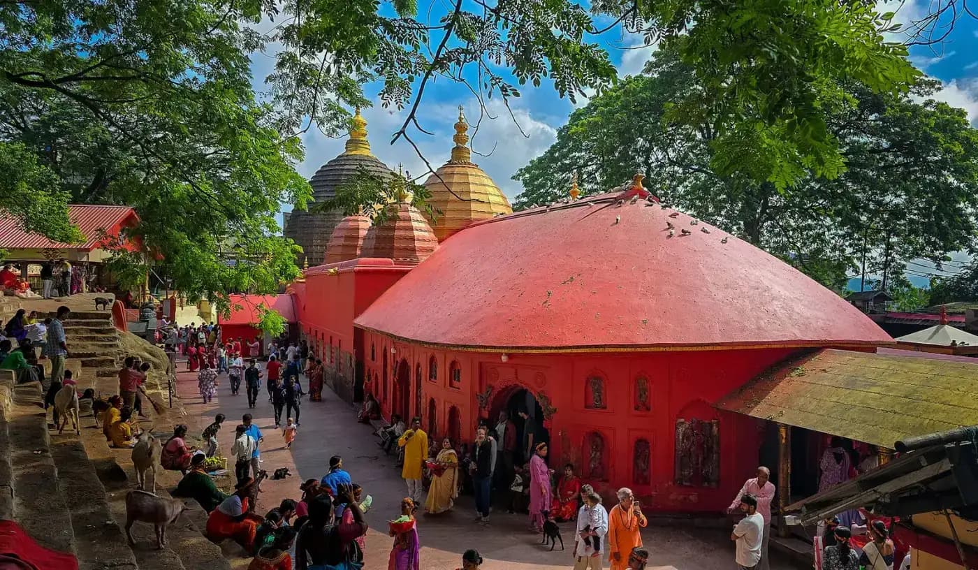 Pilgrims in the courtyard of Kamakhya Temple with its red domes