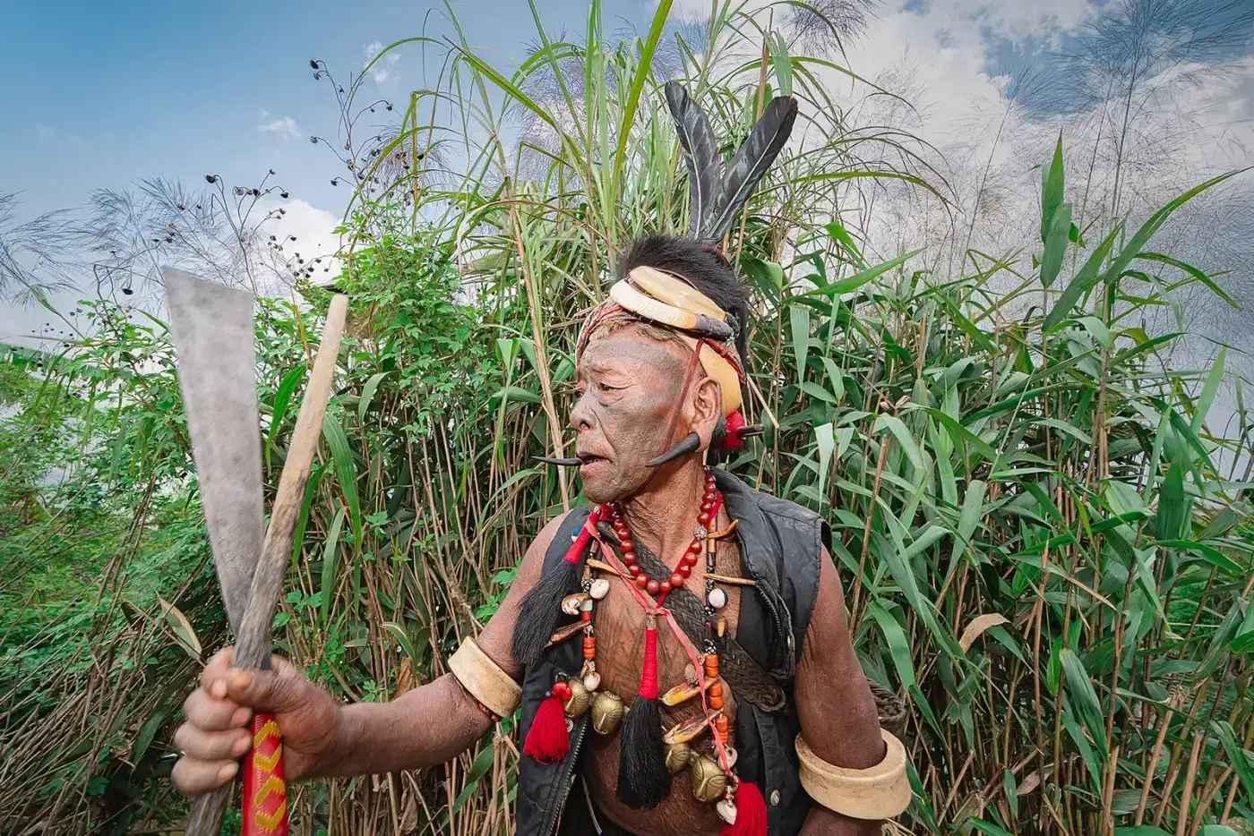 Konyak man in warrior dress holding a dao