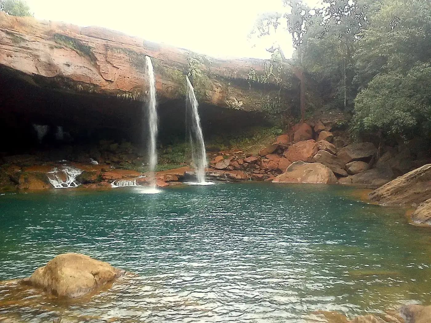 Twin streams of Krang Suri waterfall over a rock ledge