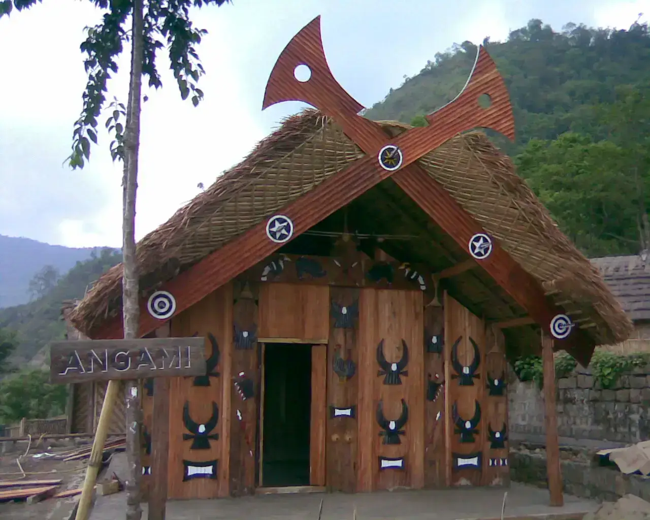 Carved Naga morung house with hornbill motifs