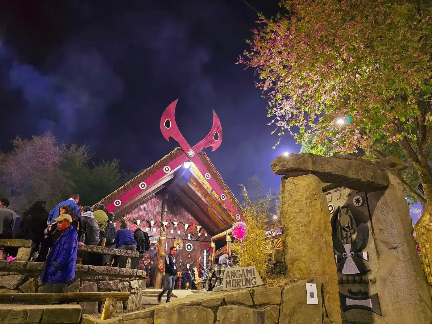 Naga morung lit at night with buffalo-horn decorations