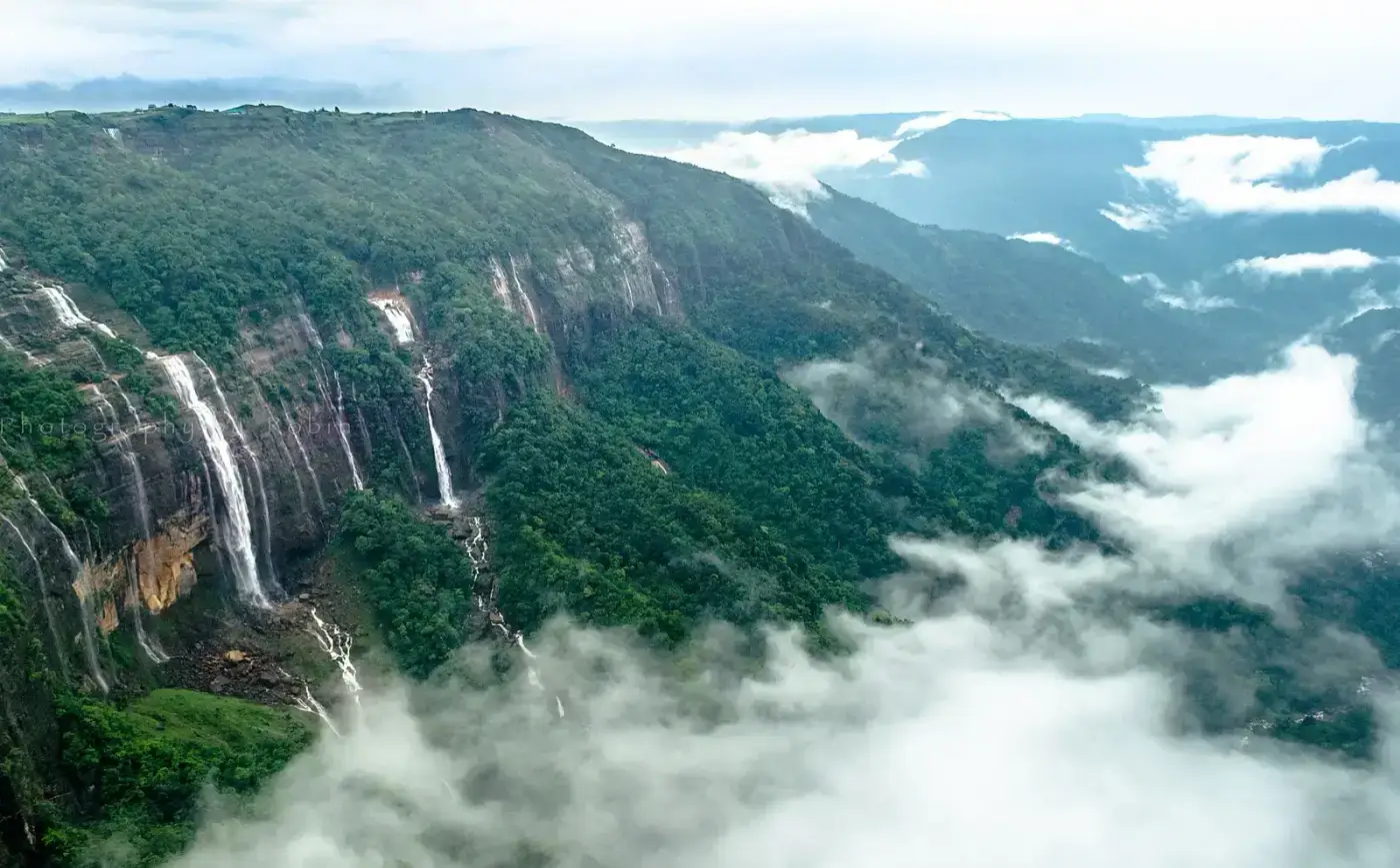 Seven Sisters Falls with clouds filling the valley below, Mawsmai
