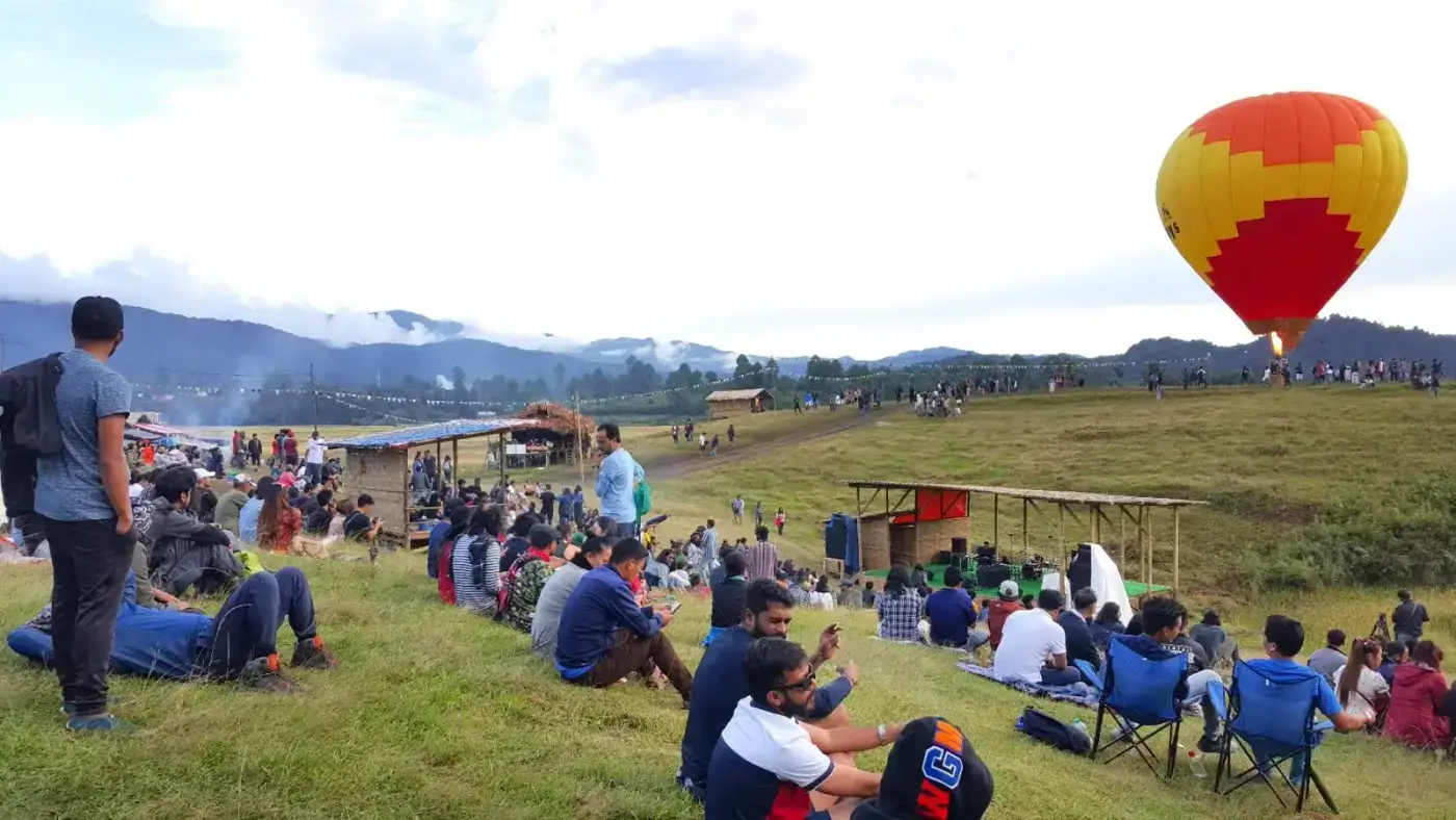 Festival-goers in the meadows at the Ziro Festival of Music