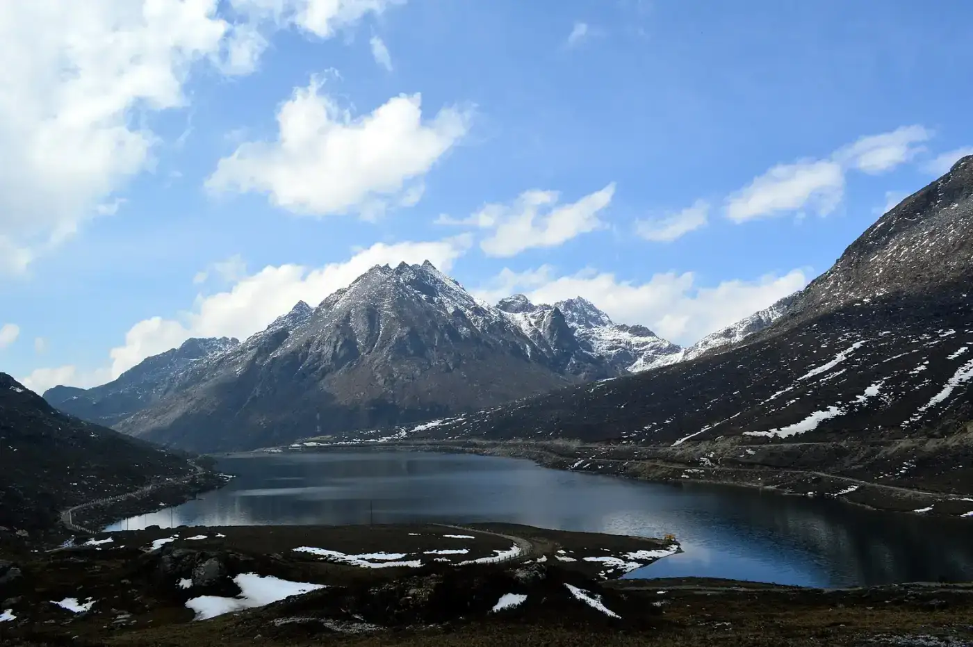 High-altitude lake and snow peaks on a trek in Arunachal Pradesh