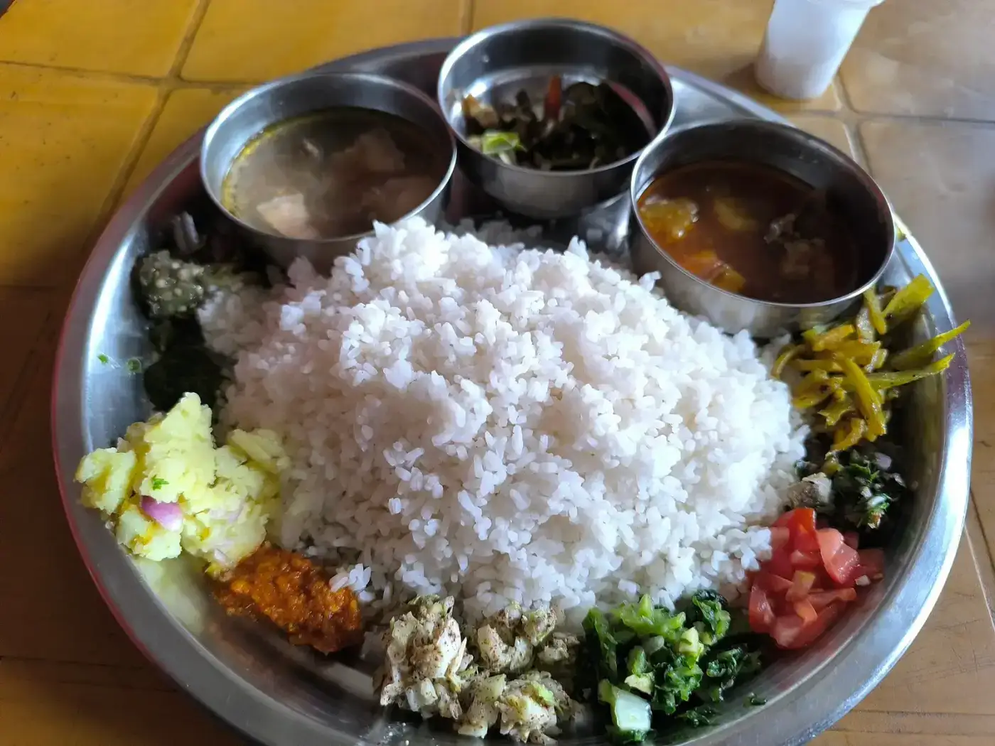 Assamese rice meal with assorted curries
