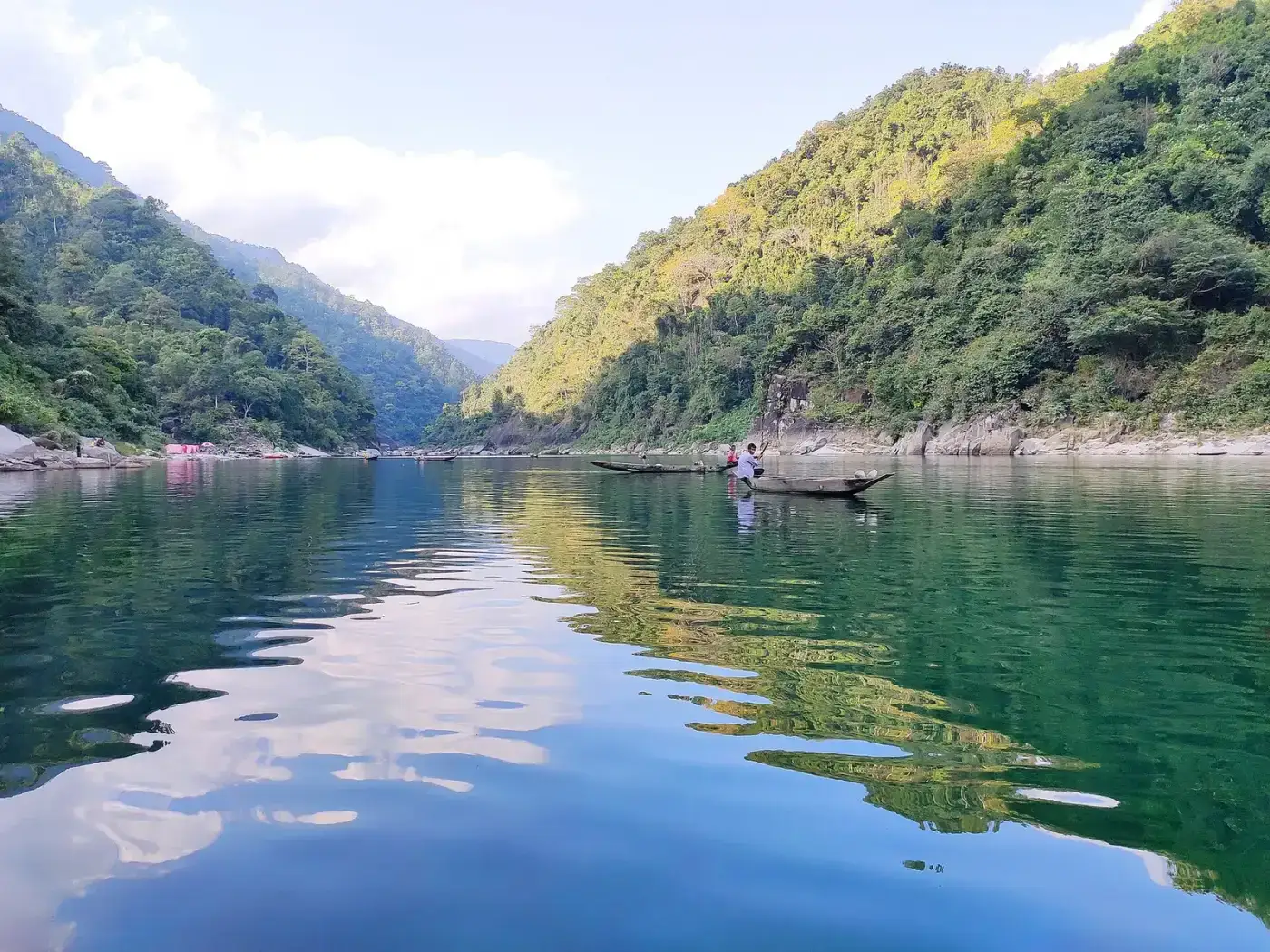 Green hills reflected in the still Umngot river at Dawki