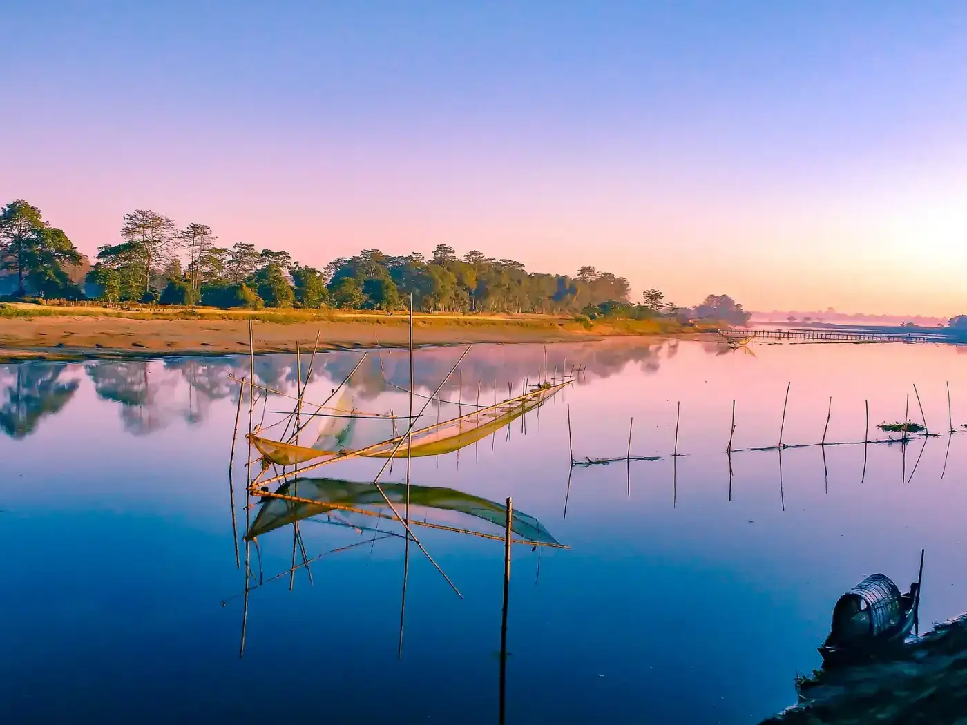 Sunrise over still water and fishing nets on Majuli Island in the Brahmaputra