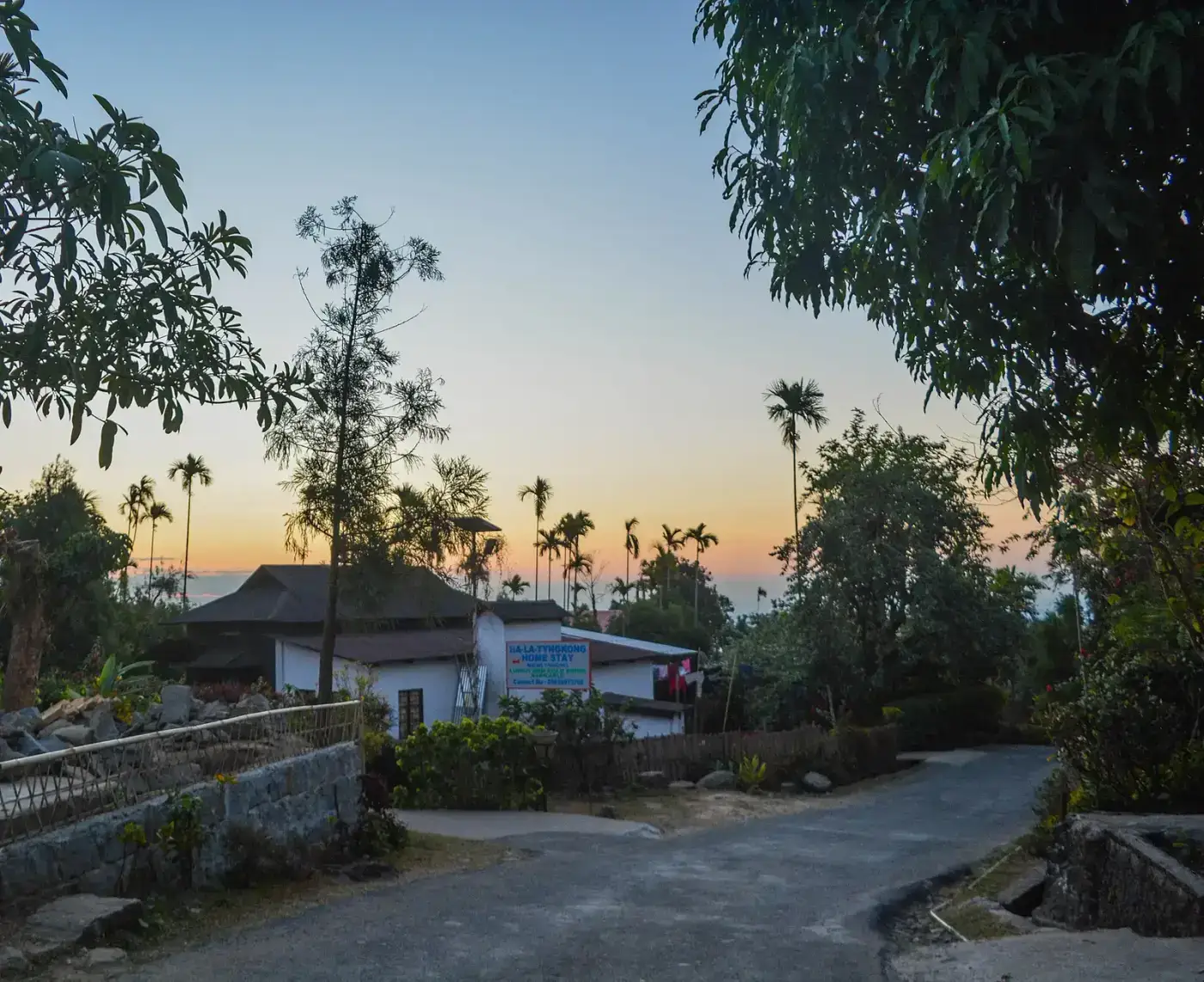 Houses and trees of Mawlynnong village at dusk