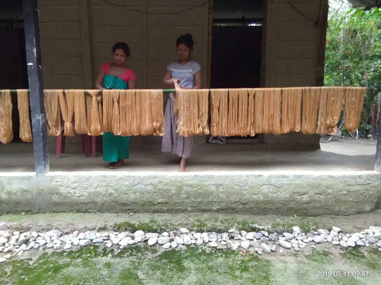 Silk yarn drying outside a weaver's home in Sualkuchi