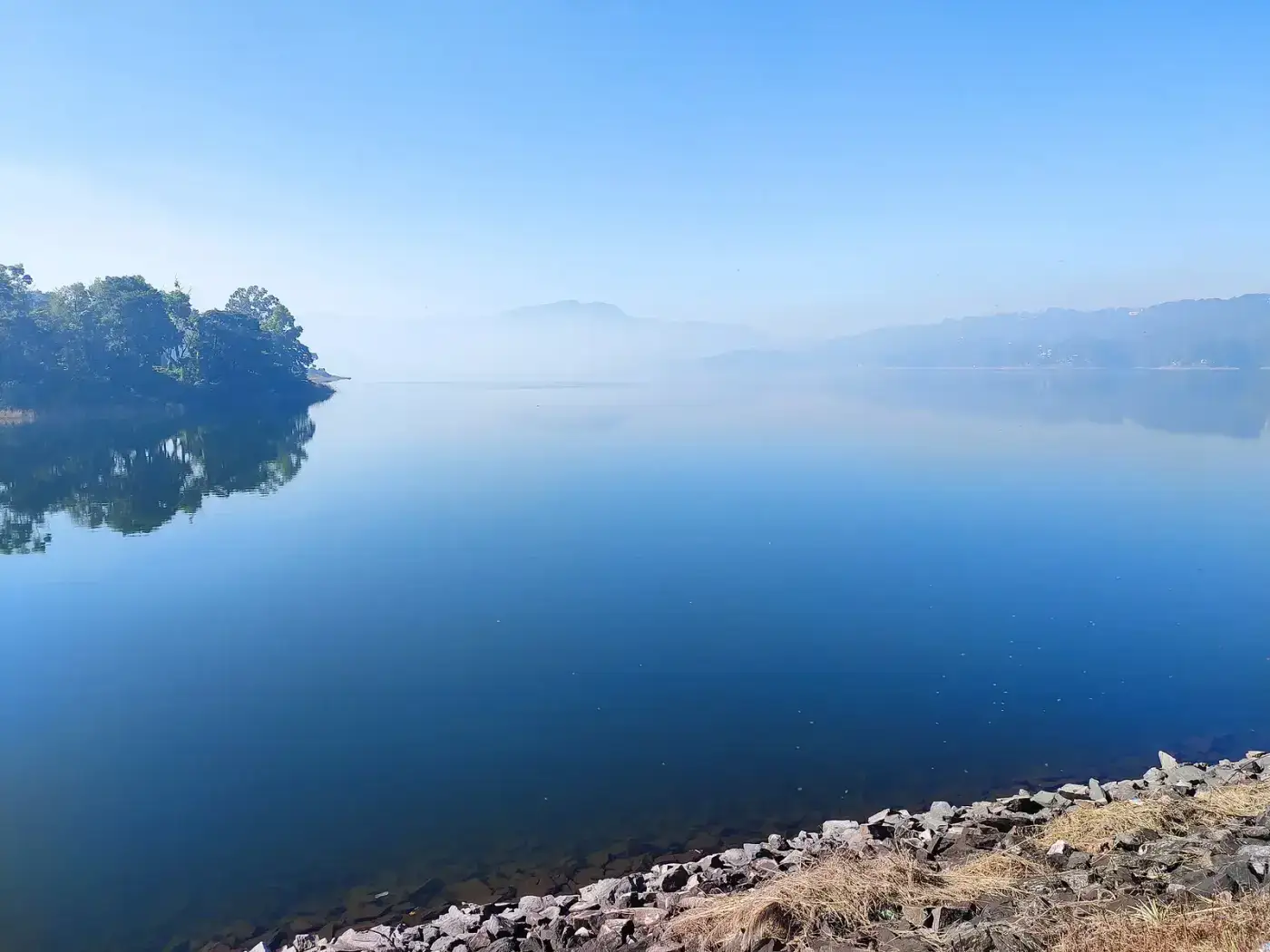 Still blue water of Umiam (Barapani) Lake, Meghalaya
